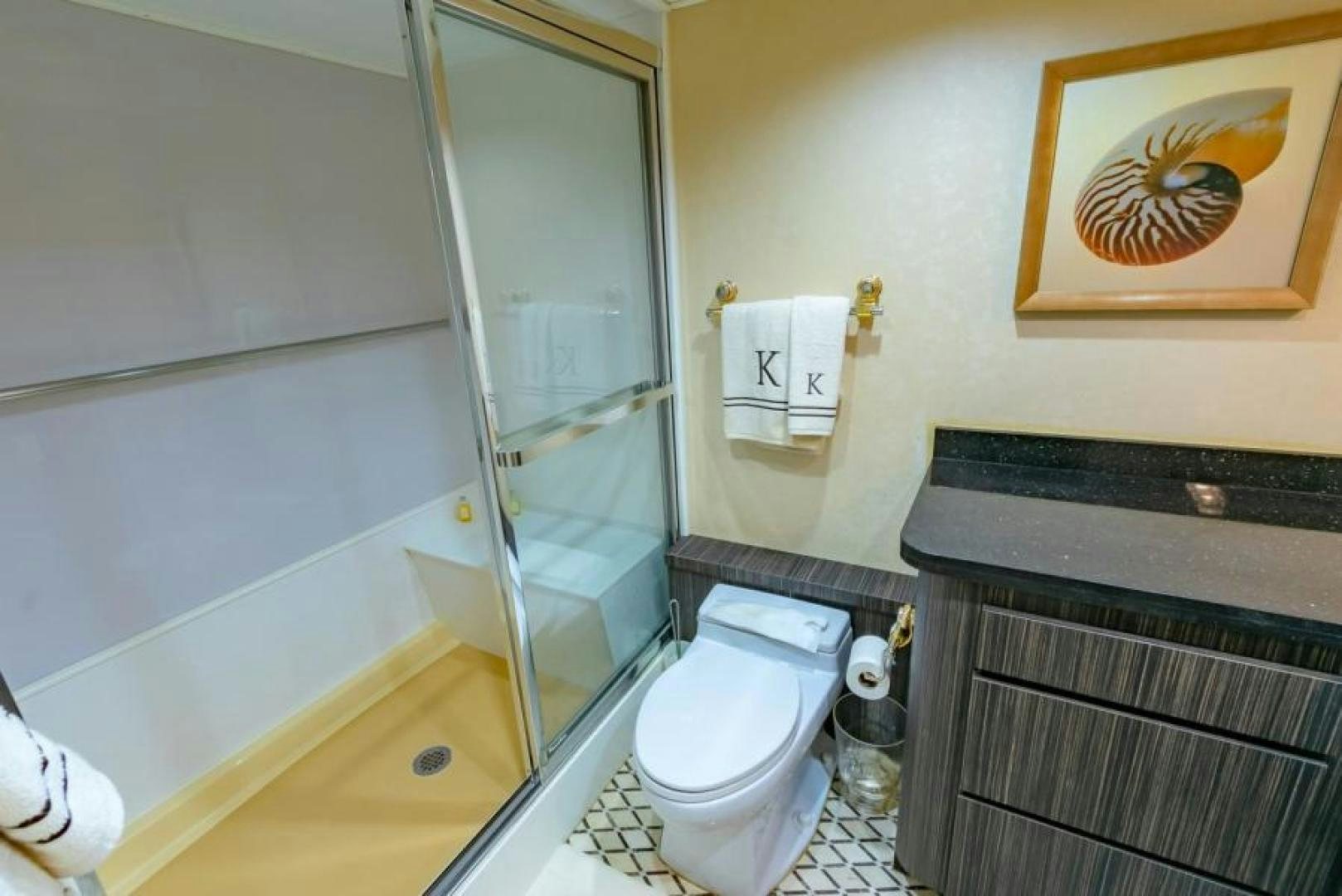a bathroom with a glass shower aboard K Yacht for Sale