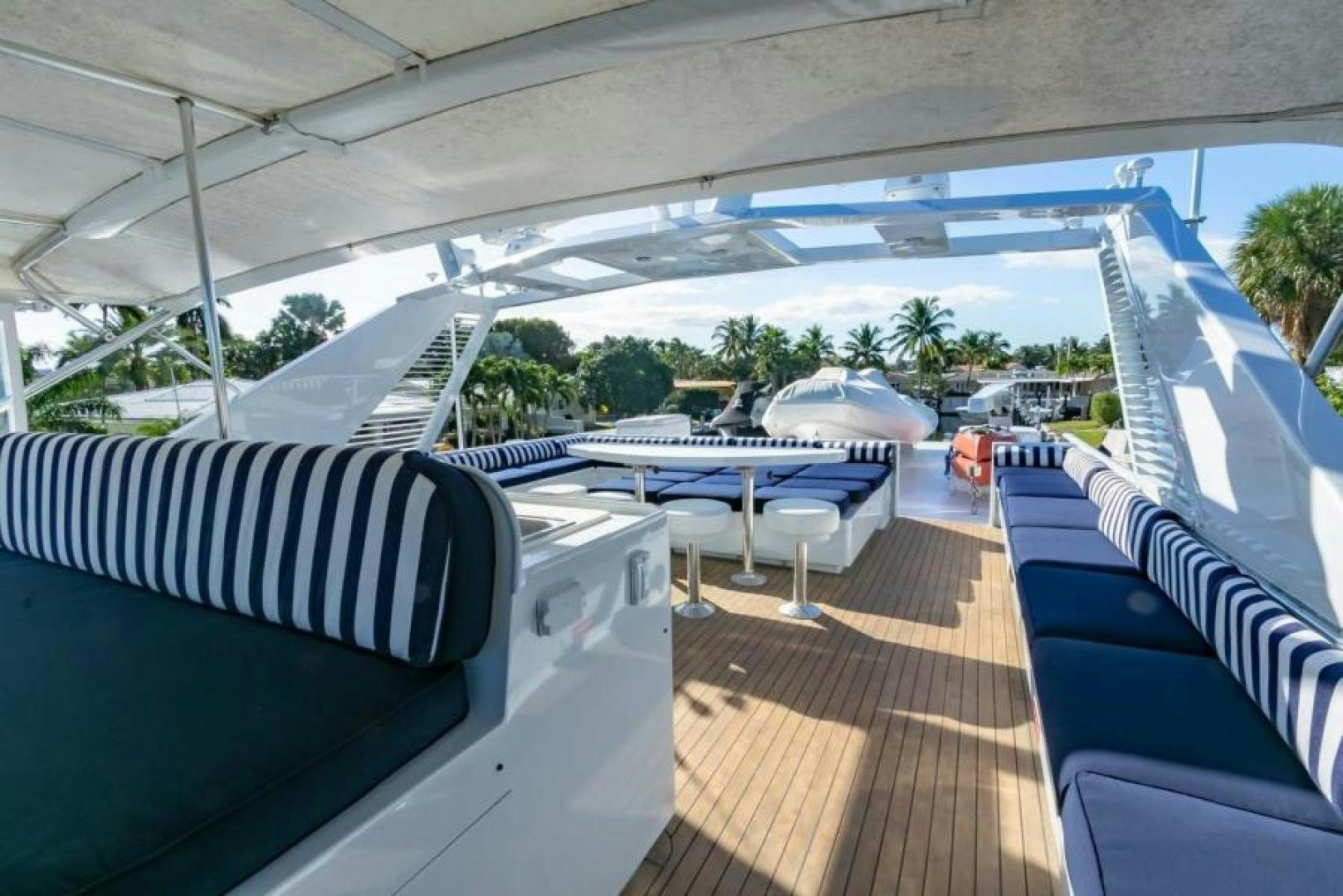 a deck with a pool and tables aboard K Yacht for Sale