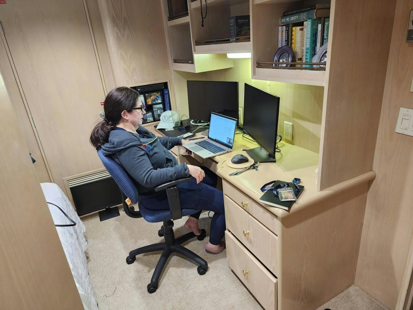 a couple of women sitting at a desk with computers aboard K Yacht for Sale
