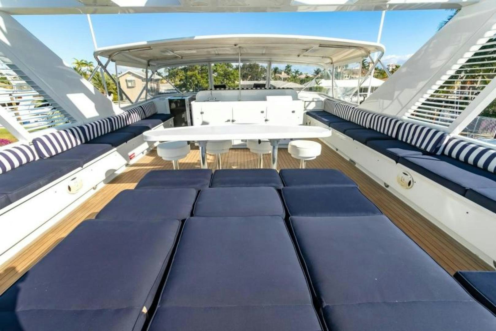 a boat with a deck and chairs aboard K Yacht for Sale