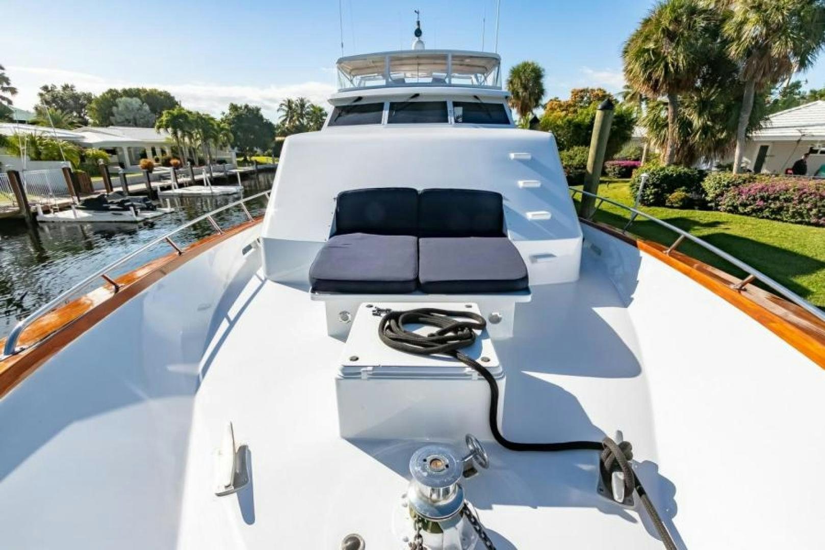 a white yacht with a black seat aboard K Yacht for Sale