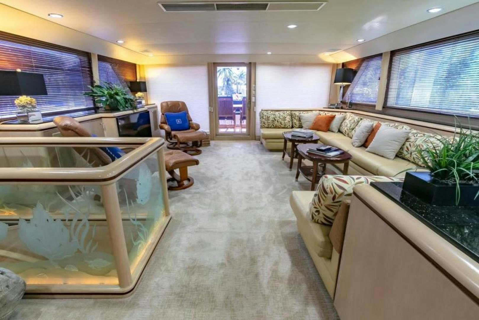 a living room with a large glass table and a large window aboard K Yacht for Sale