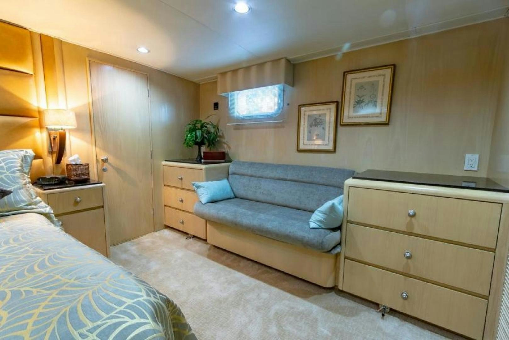 a bedroom with a bed and a desk aboard K Yacht for Sale