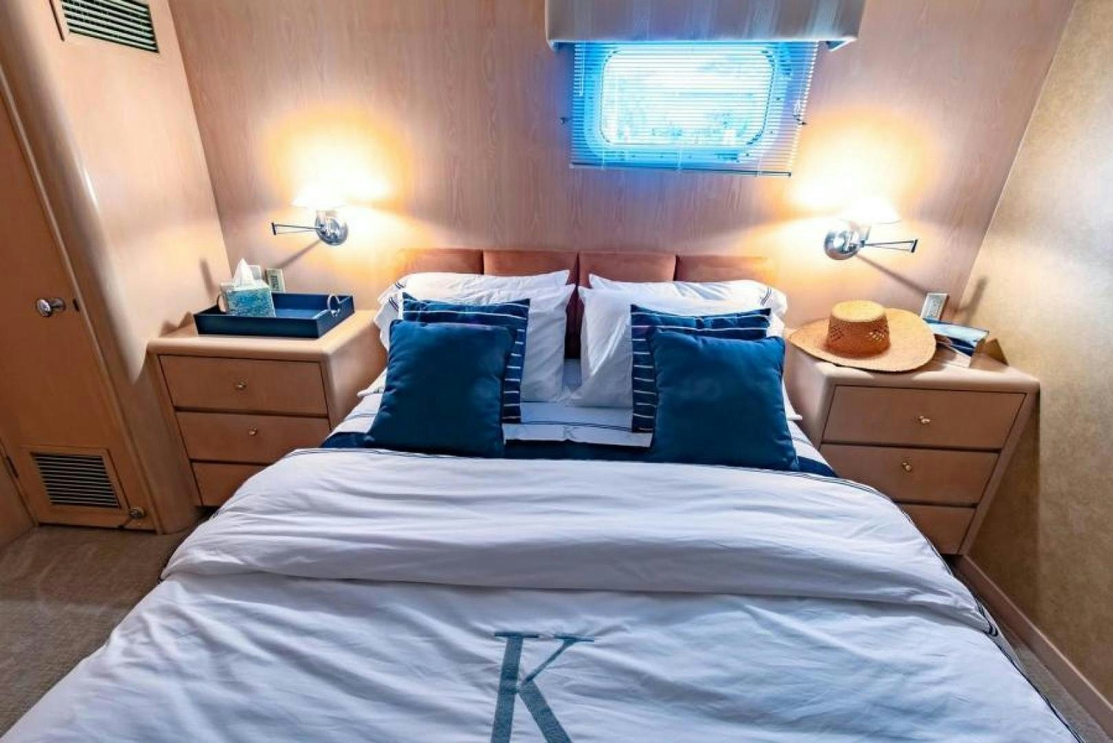 a bed with white sheets and pillows aboard K Yacht for Sale