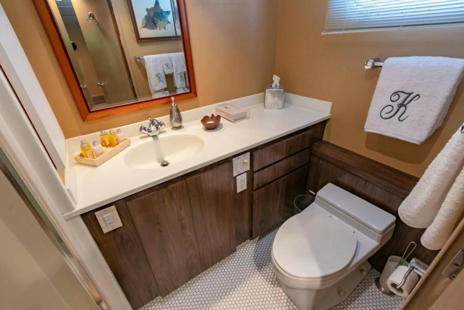 a bathroom with a sink toilet and a mirror aboard K Yacht for Sale