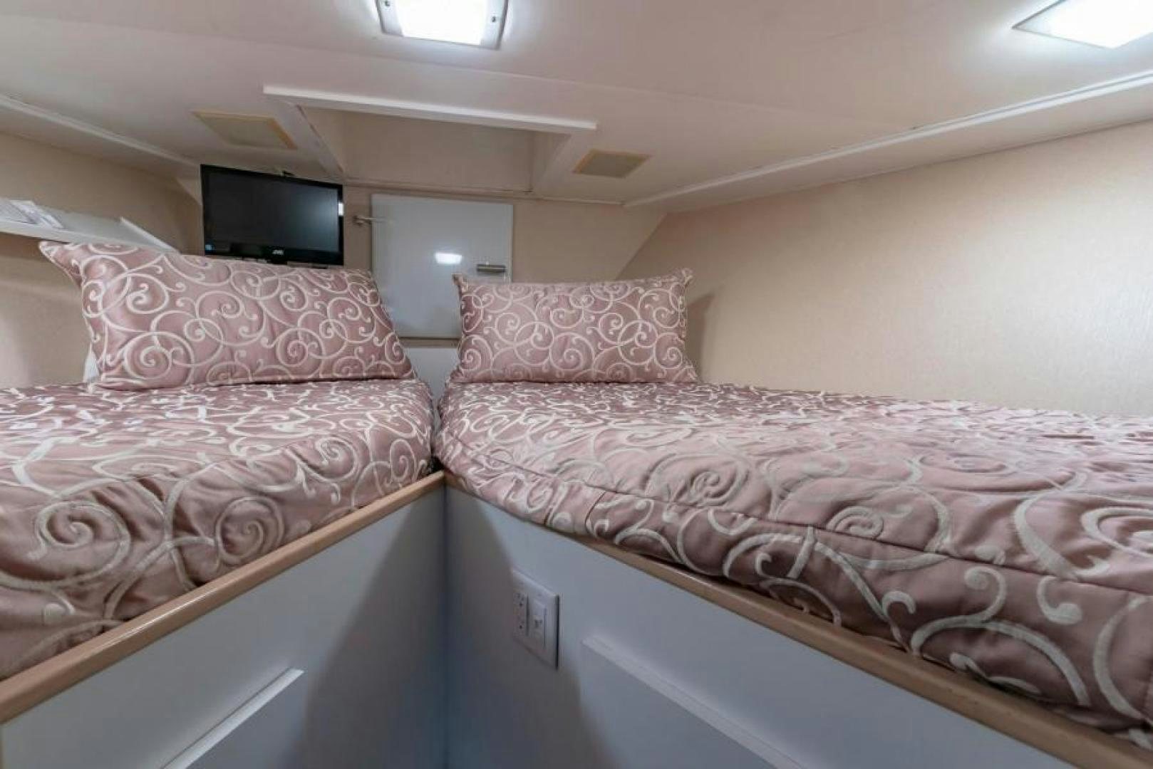 a couple of beds in a room aboard K Yacht for Sale