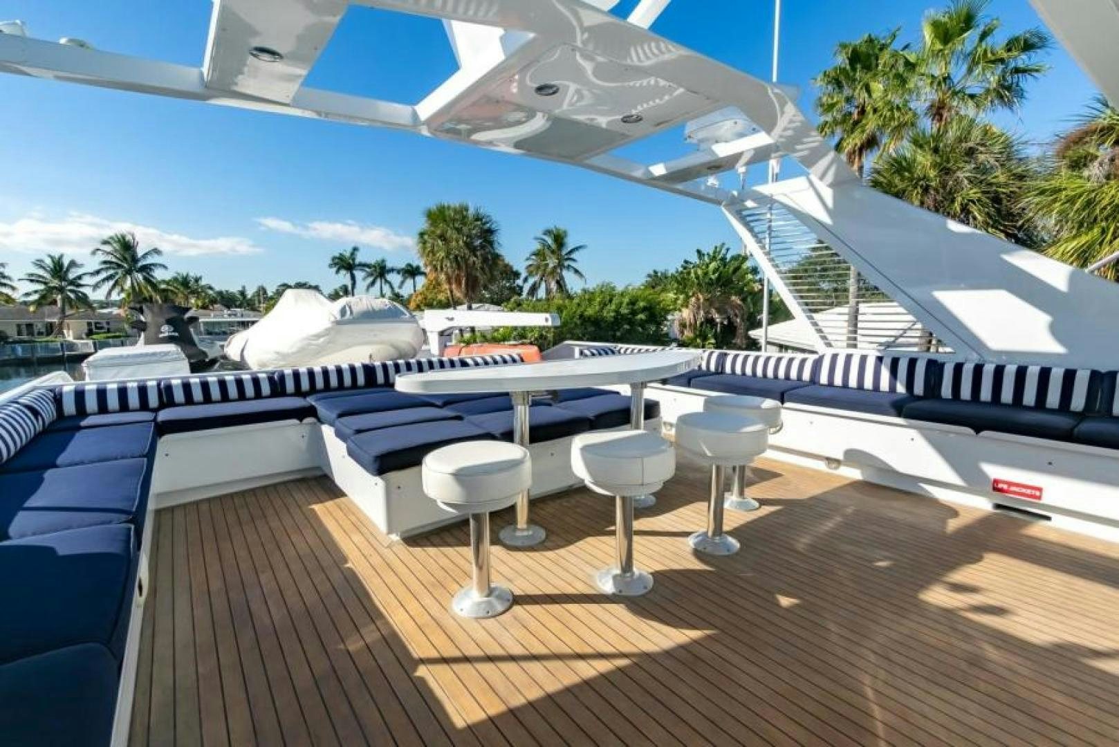 a deck with tables and chairs aboard K Yacht for Sale