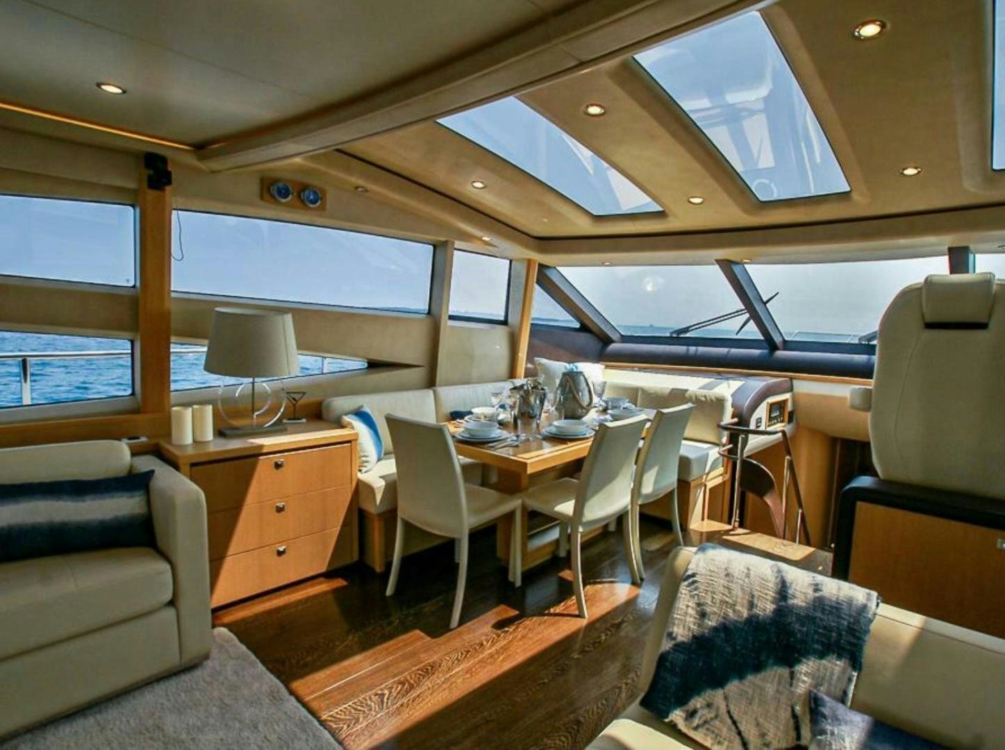 a room with a table chairs and a window aboard GITANA I Yacht for Sale