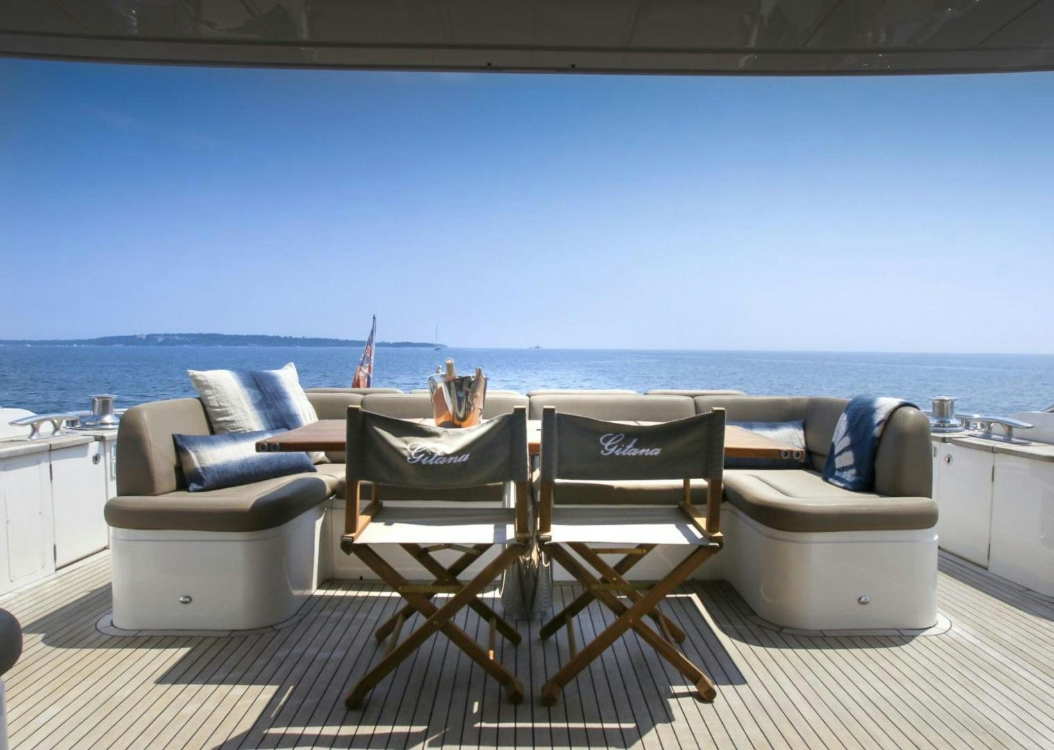 a patio with chairs and a table aboard GITANA I Yacht for Sale