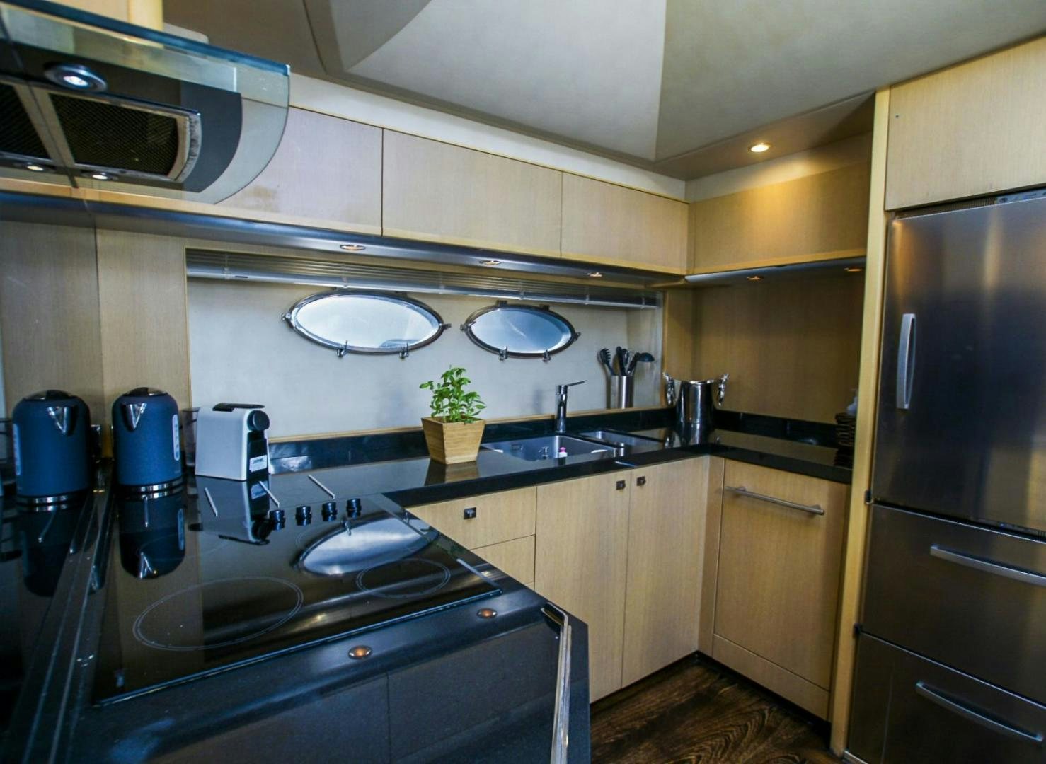 a kitchen with a stainless steel refrigerator aboard GITANA I Yacht for Sale