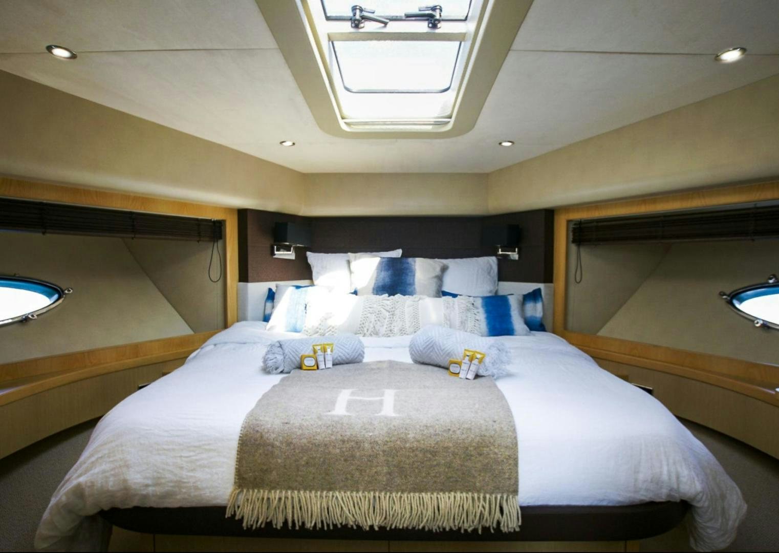 a bed with a white comforter aboard GITANA I Yacht for Sale