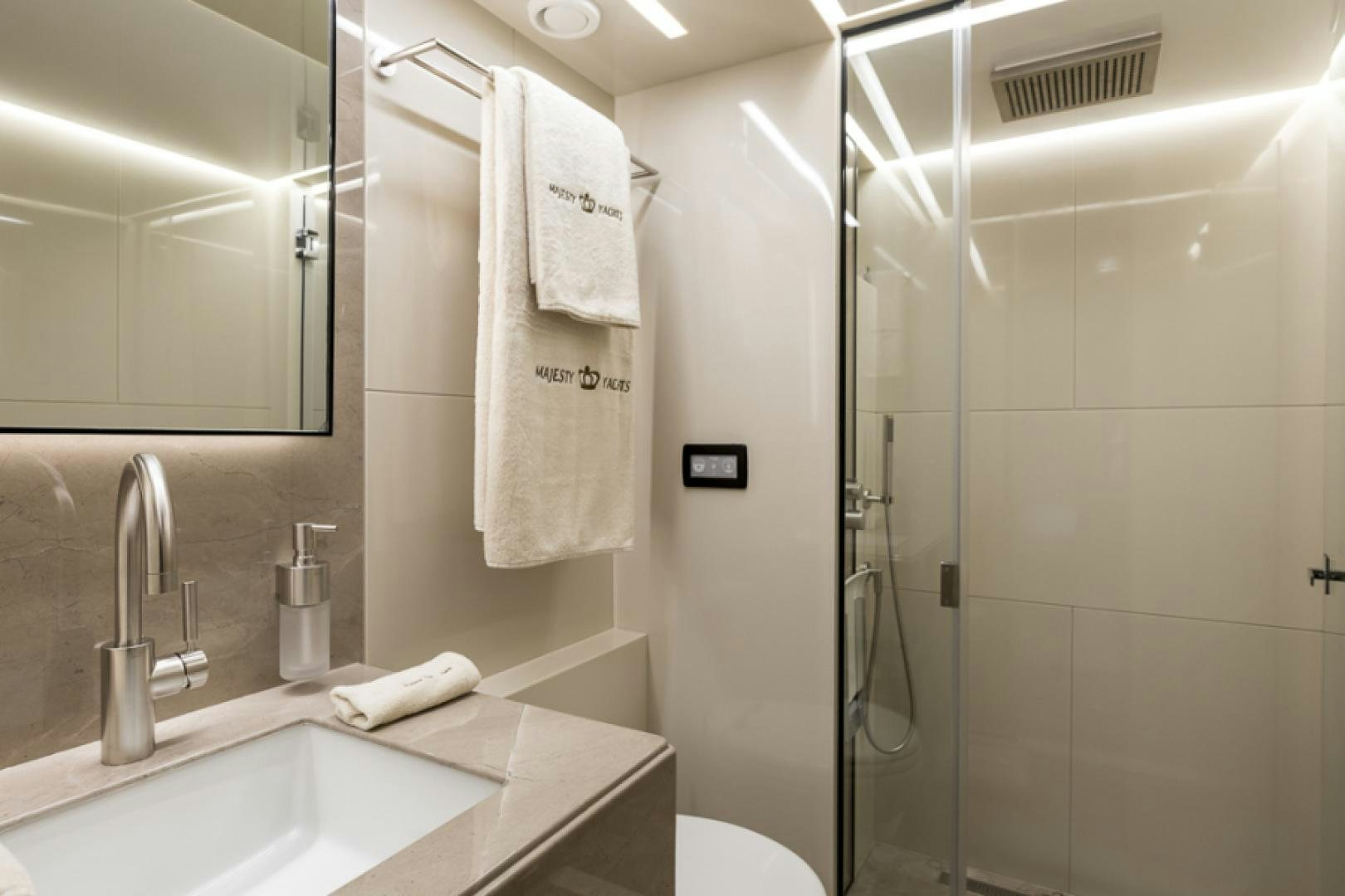 a bathroom with a glass shower aboard KRISHH Yacht for Sale