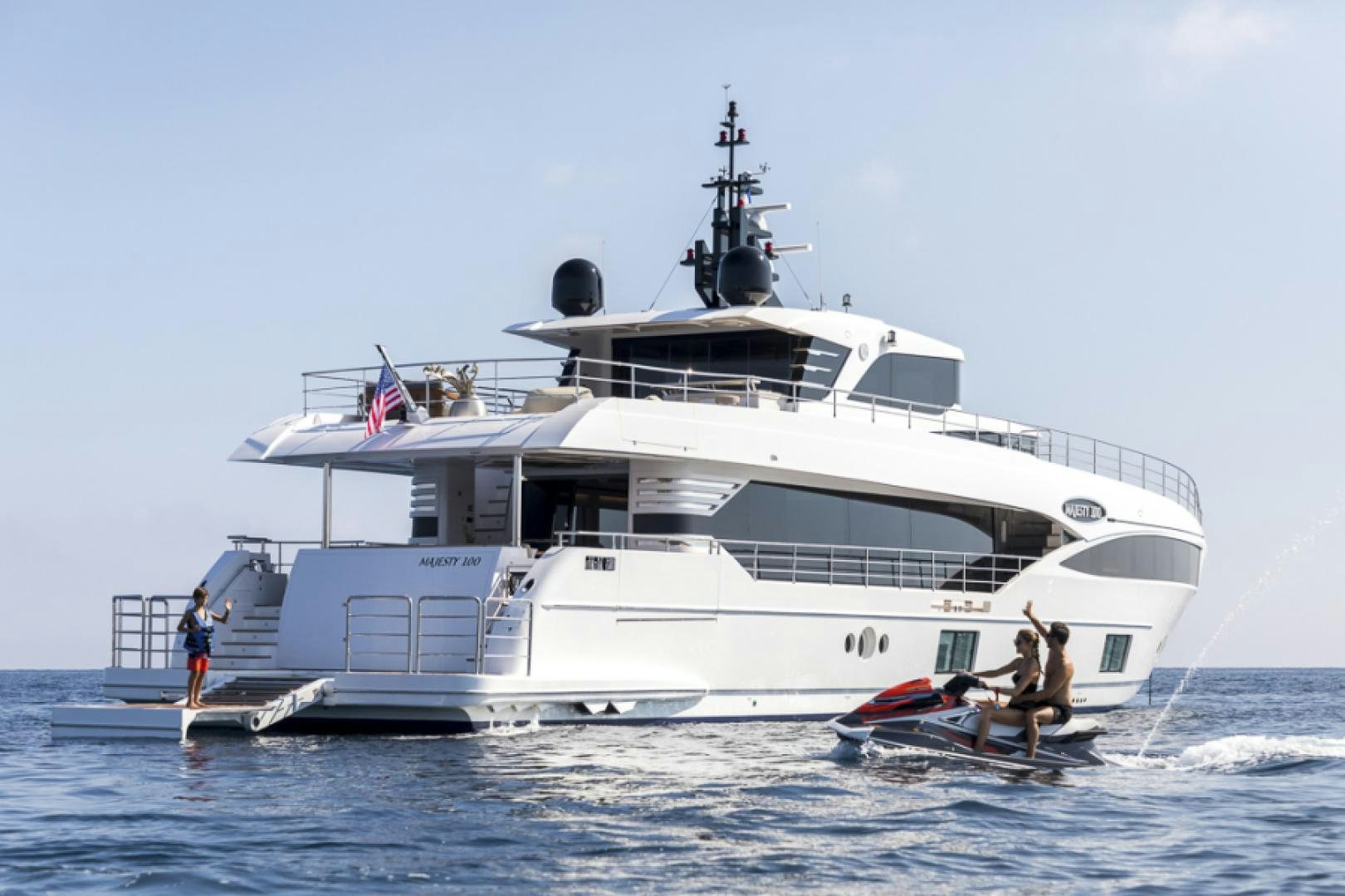 a large white boat with a couple of people on it aboard KRISHH Yacht for Sale