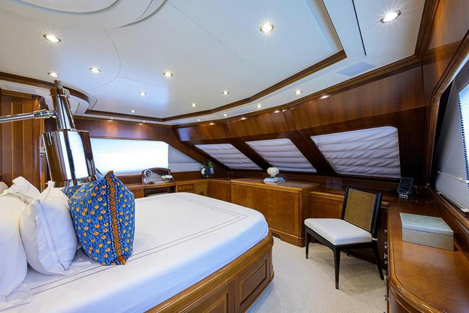 a room with a bed and a chair aboard BW Yacht for Sale