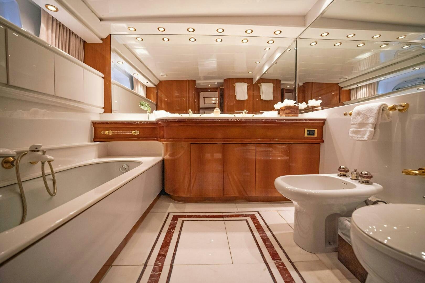a bathroom with a tub sink and toilet aboard SHALIMAR Yacht for Sale