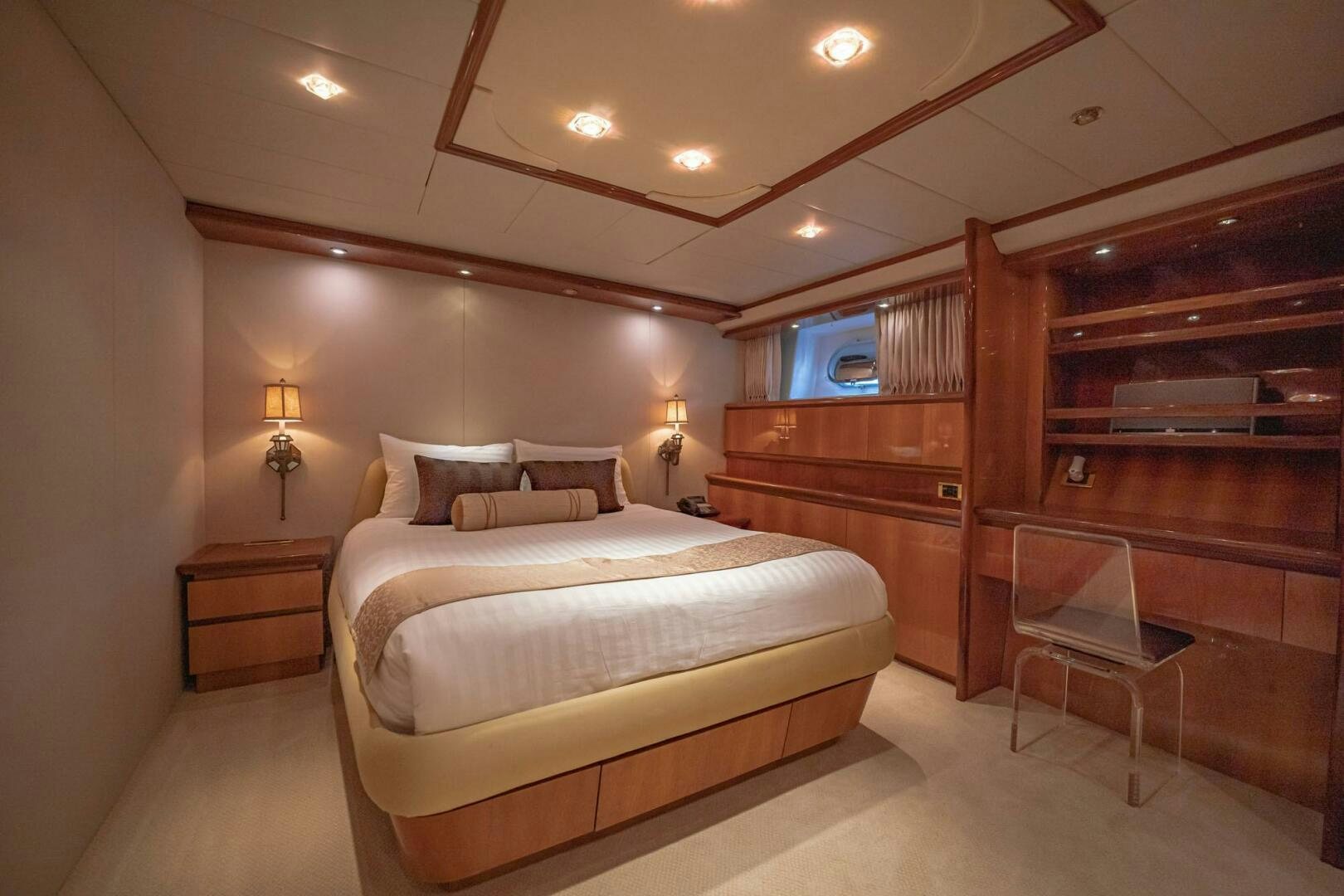 a bedroom with a bed and a chair aboard SHALIMAR Yacht for Sale
