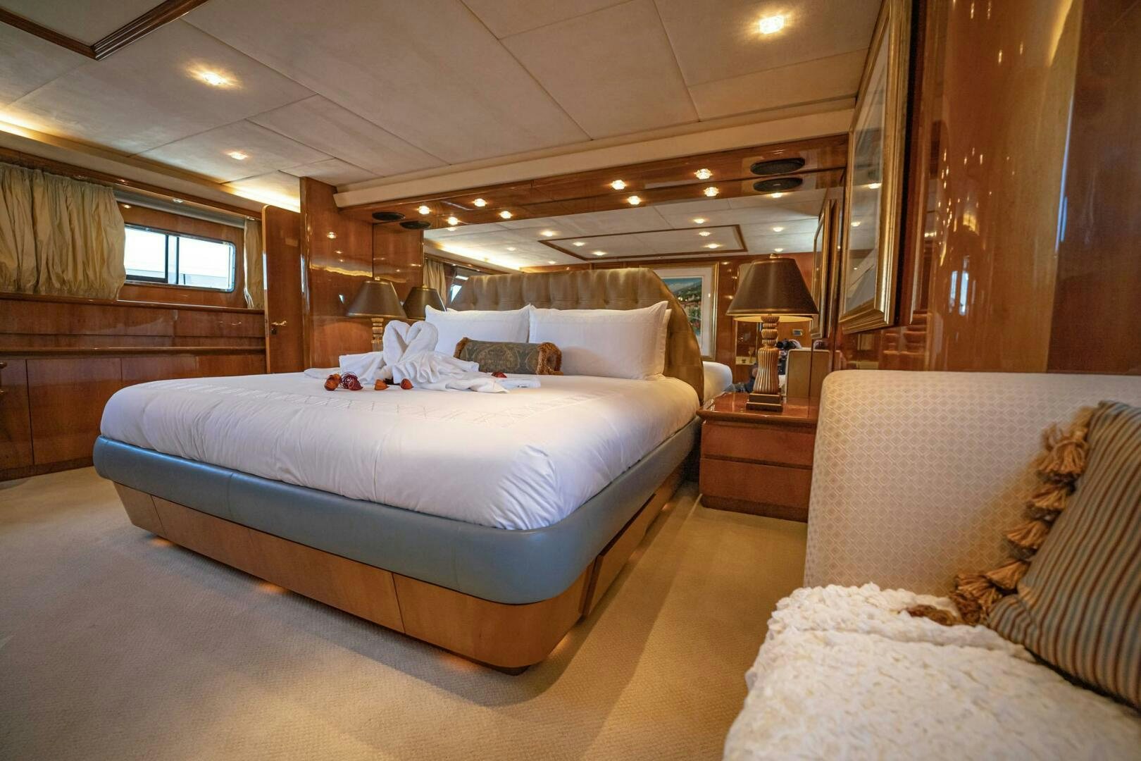 a room with a bed and a lamp aboard SHALIMAR Yacht for Sale