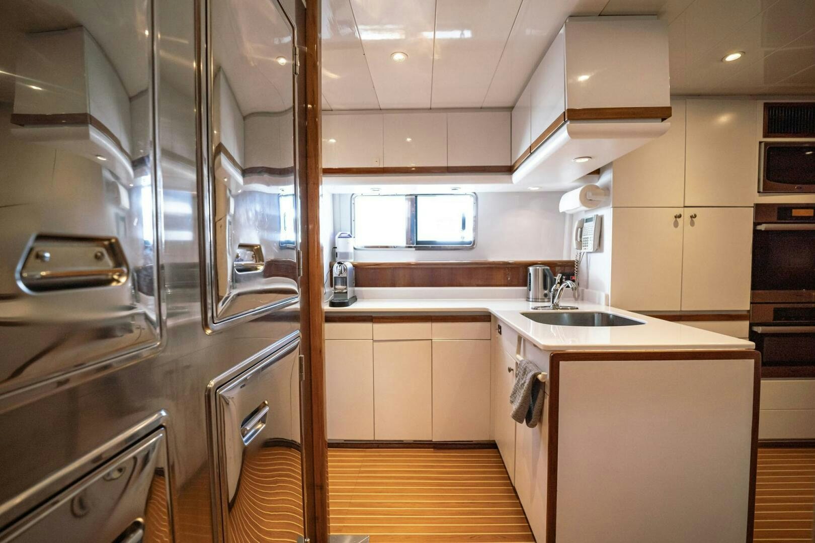 a kitchen with a stainless steel refrigerator aboard SHALIMAR Yacht for Sale