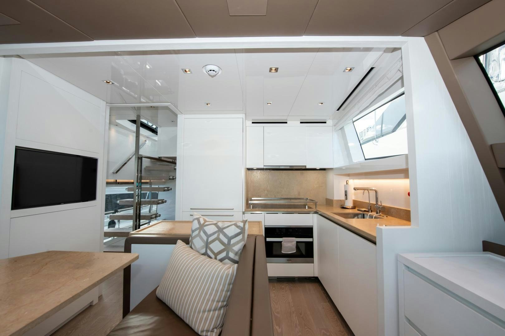 a small living room with a small kitchen aboard MARAVI Yacht for Sale