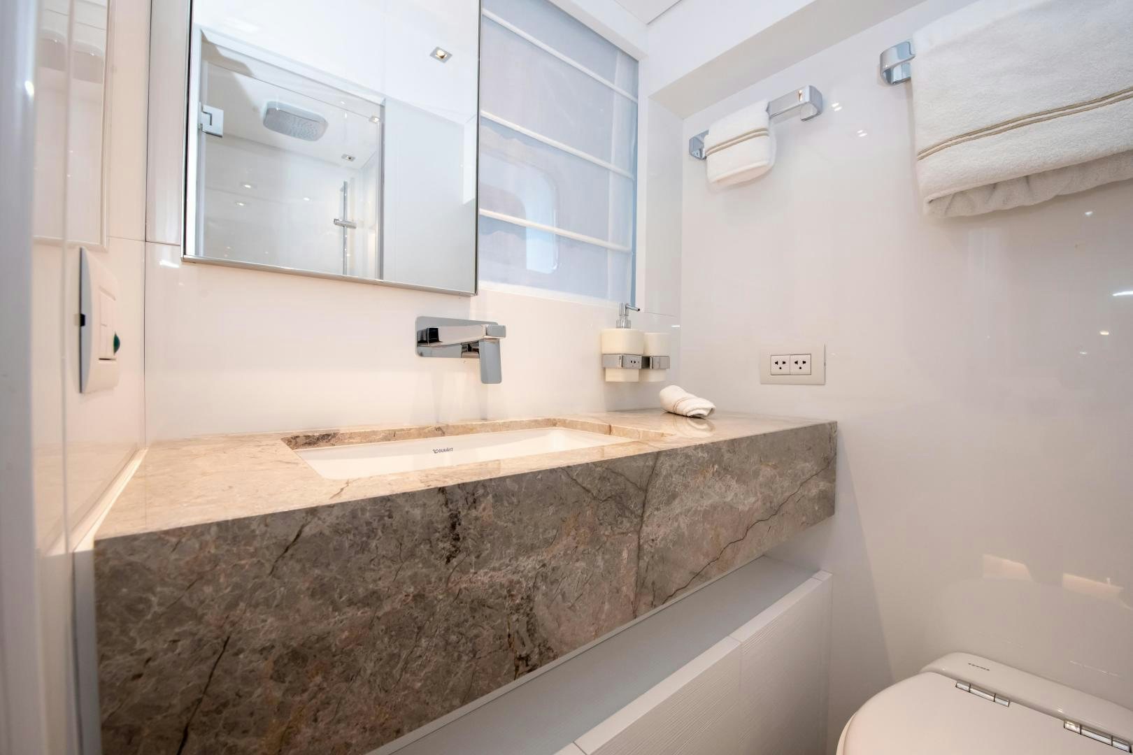a bathroom with a marble counter top aboard MARAVI Yacht for Sale