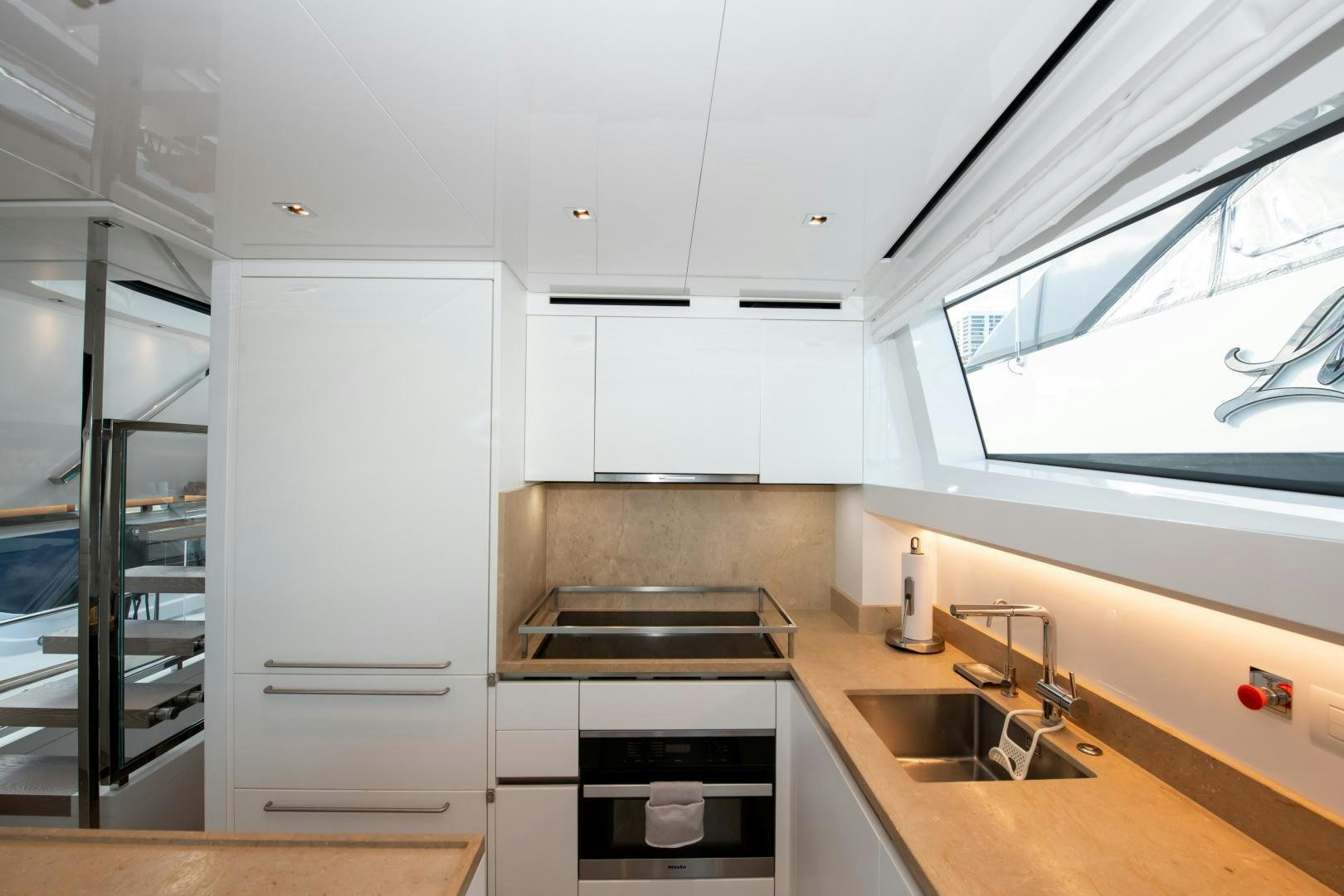 a kitchen with white cabinets aboard MARAVI Yacht for Sale