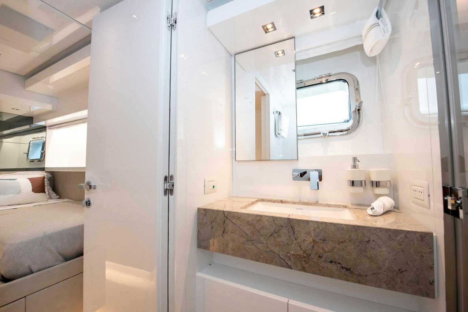 a bathroom with a countertop sink and a mirror aboard MARAVI Yacht for Sale