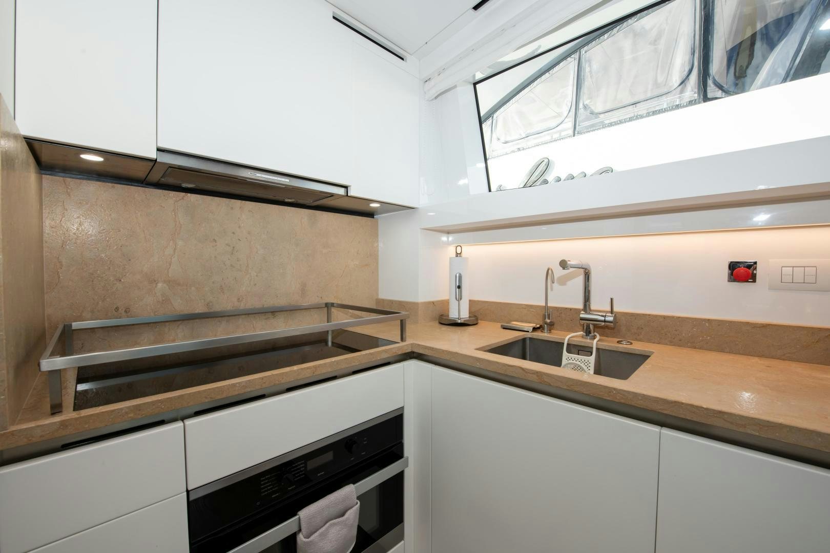 a kitchen with a sink and a window aboard MARAVI Yacht for Sale