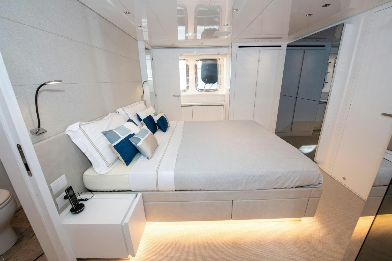 a bedroom with a bed and a window aboard MARAVI Yacht for Sale
