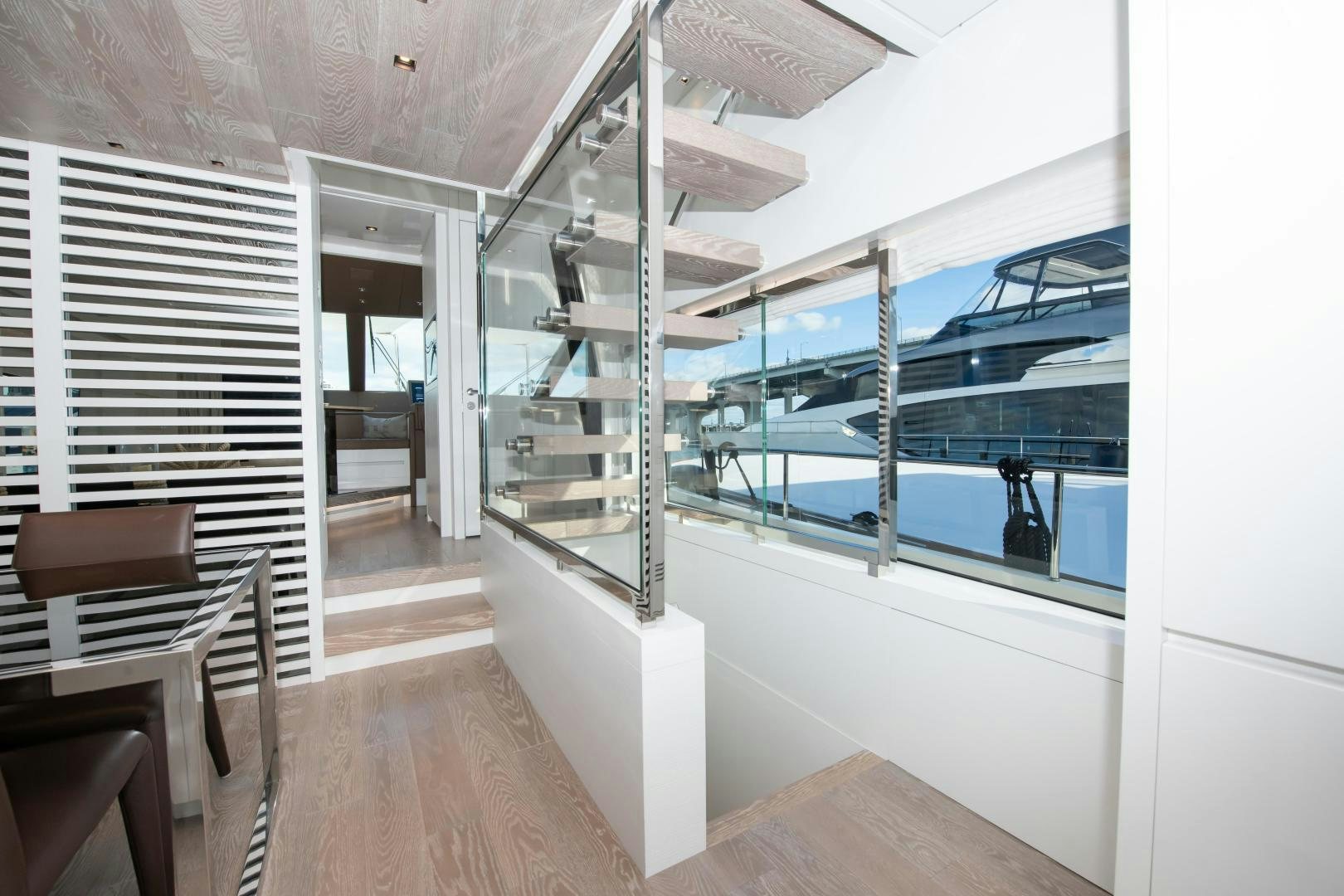 a room with a staircase and a glass wall aboard MARAVI Yacht for Sale