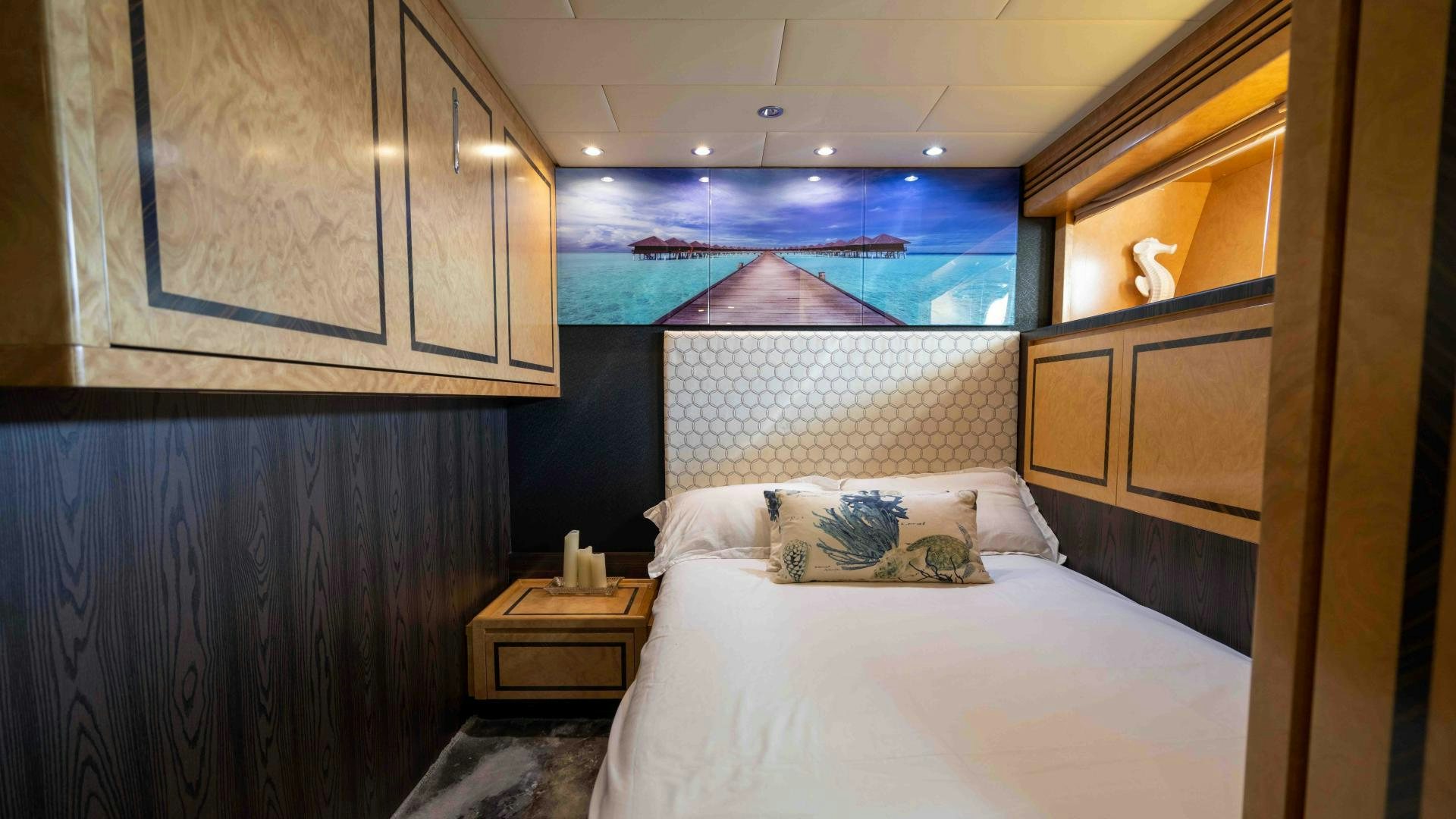 a room with a bed and a window aboard ENCORE Yacht for Sale