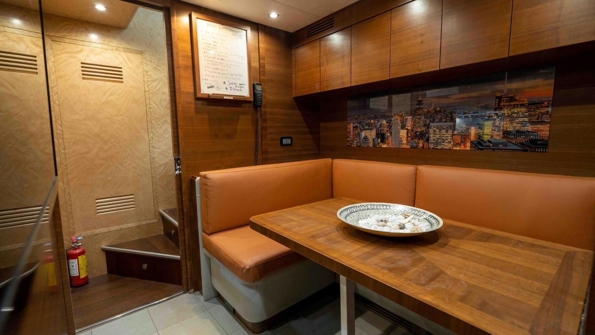 a room with a table and chairs aboard ENCORE Yacht for Sale