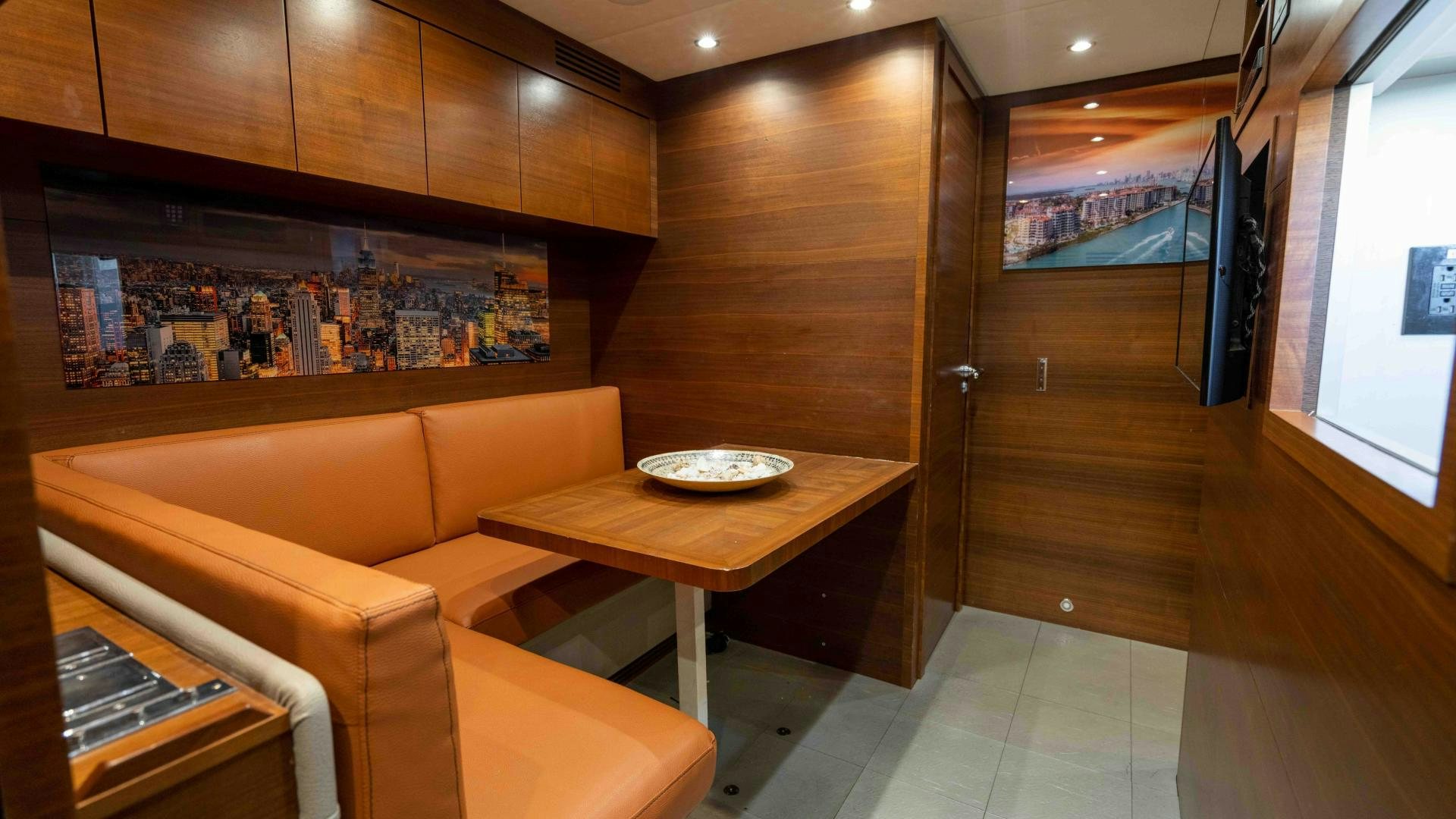 a room with a table and couches aboard ENCORE Yacht for Sale