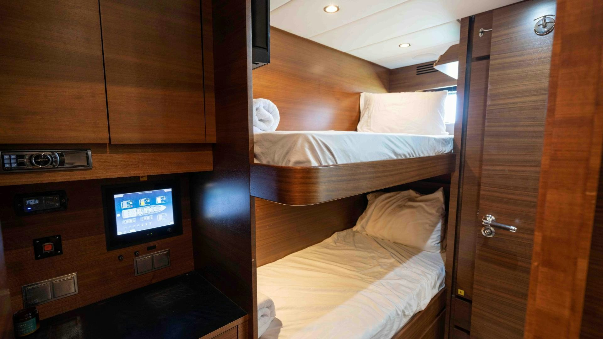a room with a bed and a television aboard ENCORE Yacht for Sale