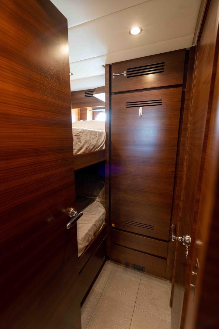 a closet with a bed and a mirror aboard ENCORE Yacht for Sale
