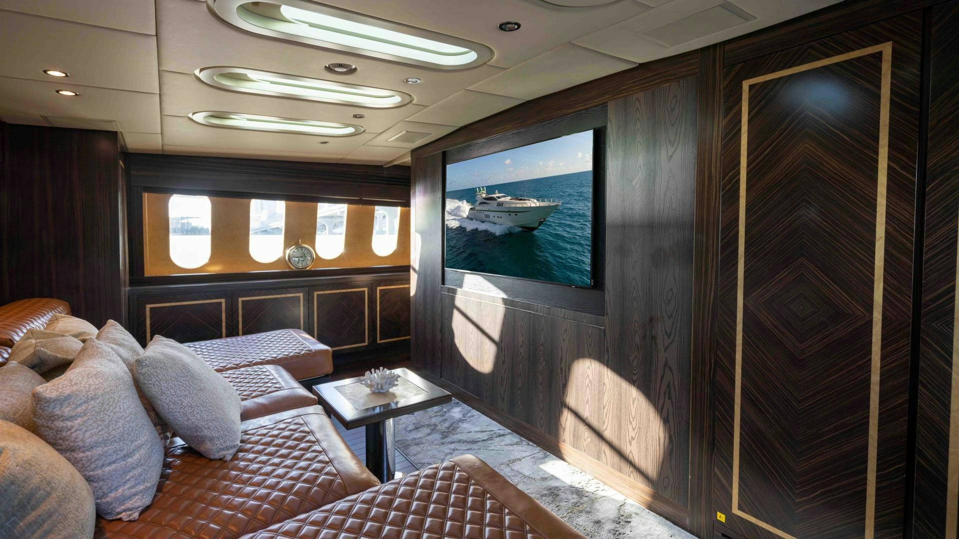 a living room with a tv aboard ENCORE Yacht for Sale