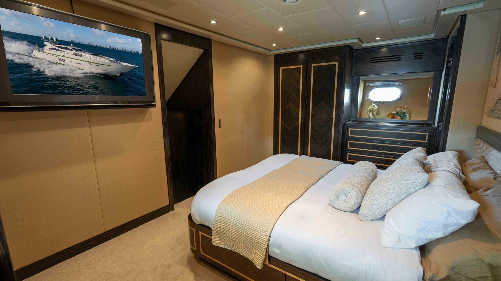 a room with a bed and a tv on the wall aboard ENCORE Yacht for Sale