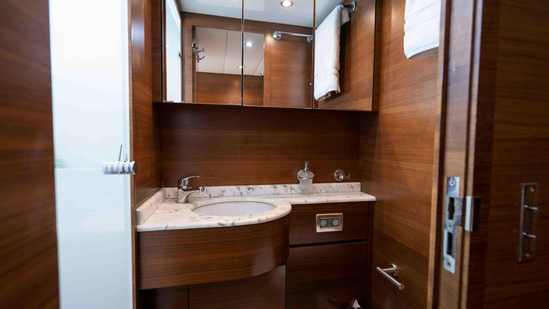 a bathroom with a sink and cabinets aboard ENCORE Yacht for Sale
