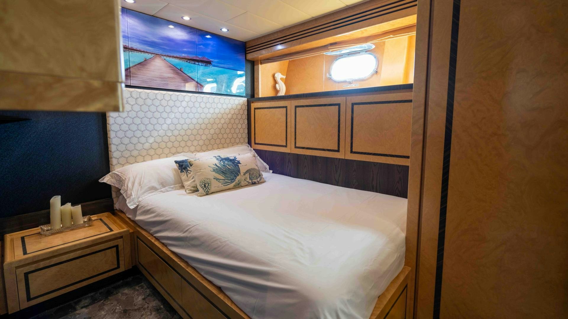 a bedroom with a bed and a dresser aboard ENCORE Yacht for Sale