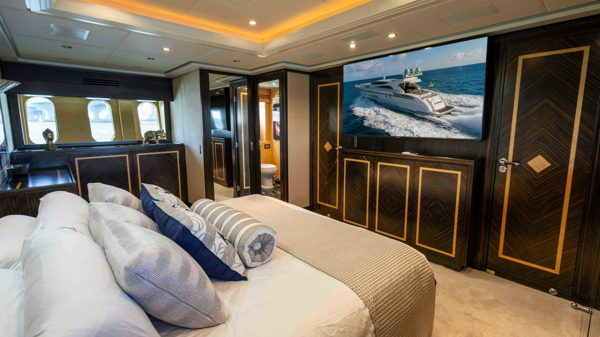 a room with a bed and a television aboard ENCORE Yacht for Sale
