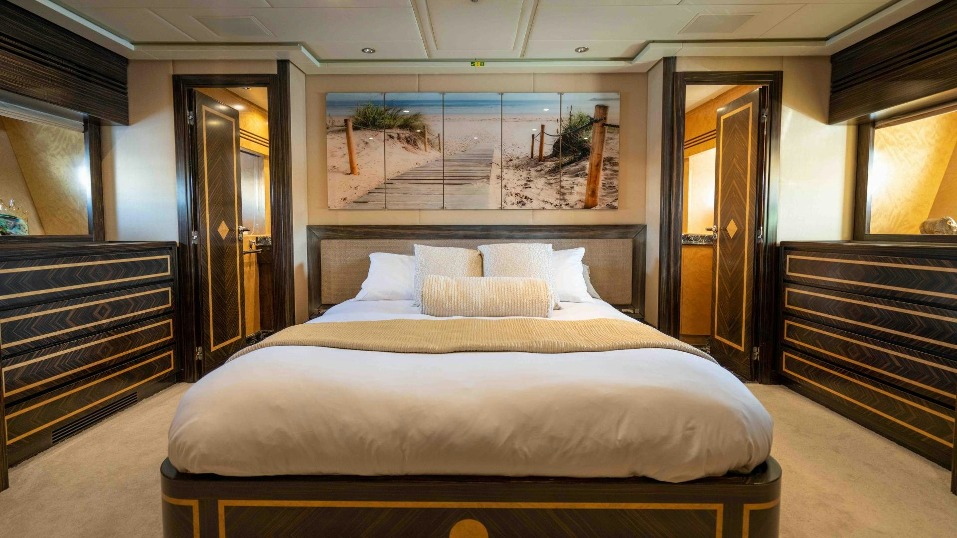 a large bed in a room aboard ENCORE Yacht for Sale