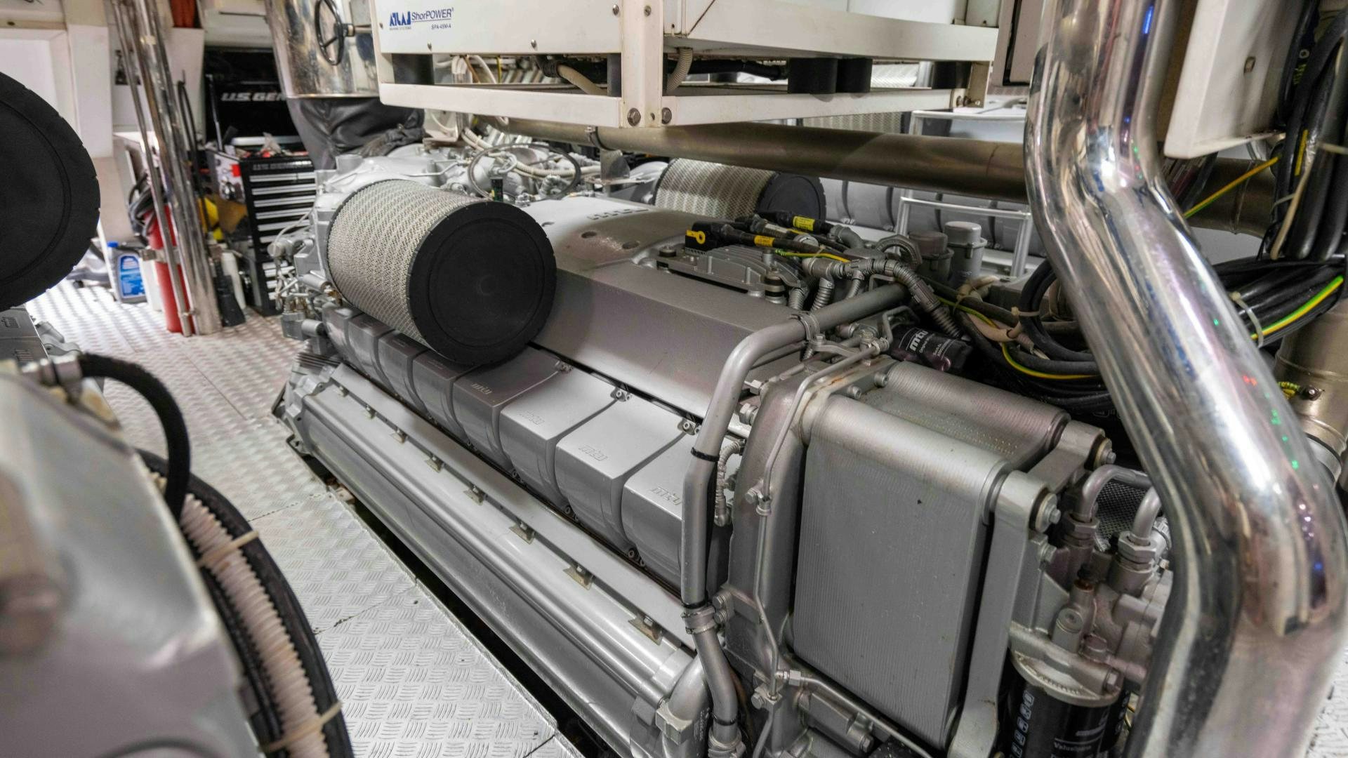 a car engine with a large metal pipe aboard ENCORE Yacht for Sale