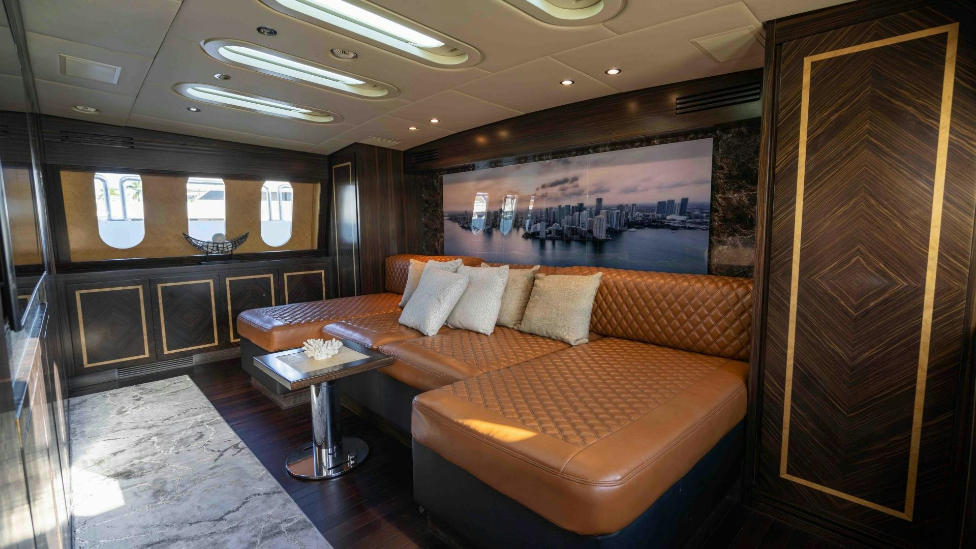 a room with a bed and a table aboard ENCORE Yacht for Sale