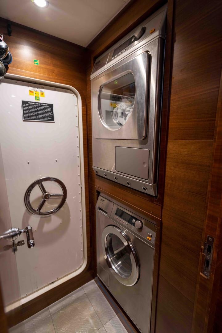 a washer and dryer in a room aboard ENCORE Yacht for Sale