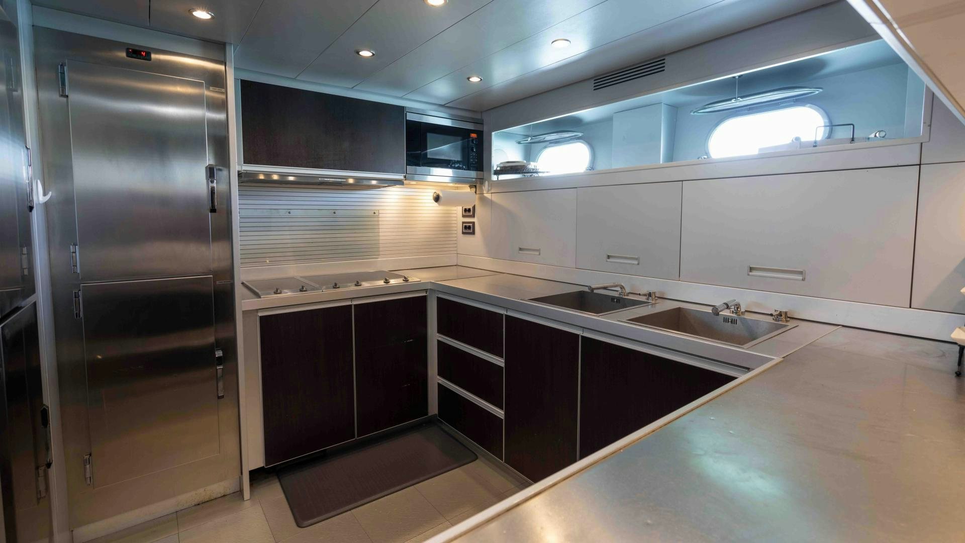a kitchen with a refrigerator and sink aboard ENCORE Yacht for Sale