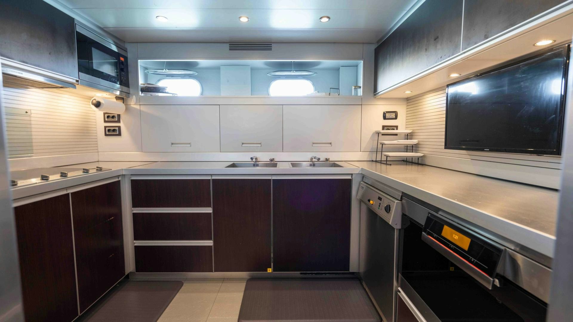 a kitchen with a large tv aboard ENCORE Yacht for Sale