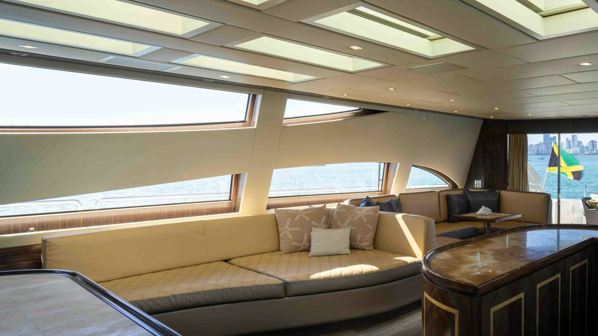 a living room with a couch and a table aboard ENCORE Yacht for Sale