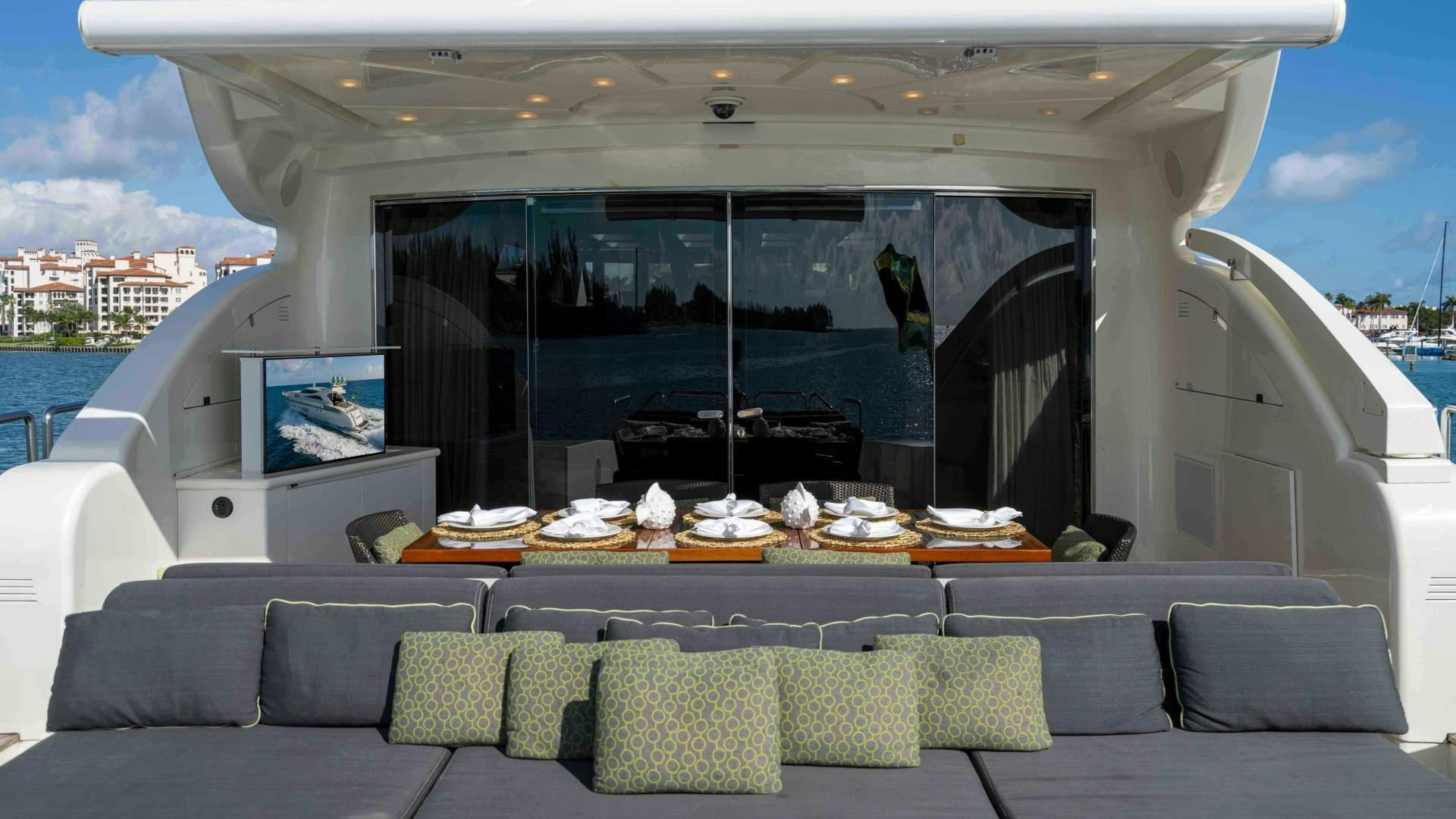 a boat with a couch and a table and chairs on the deck aboard ENCORE Yacht for Sale