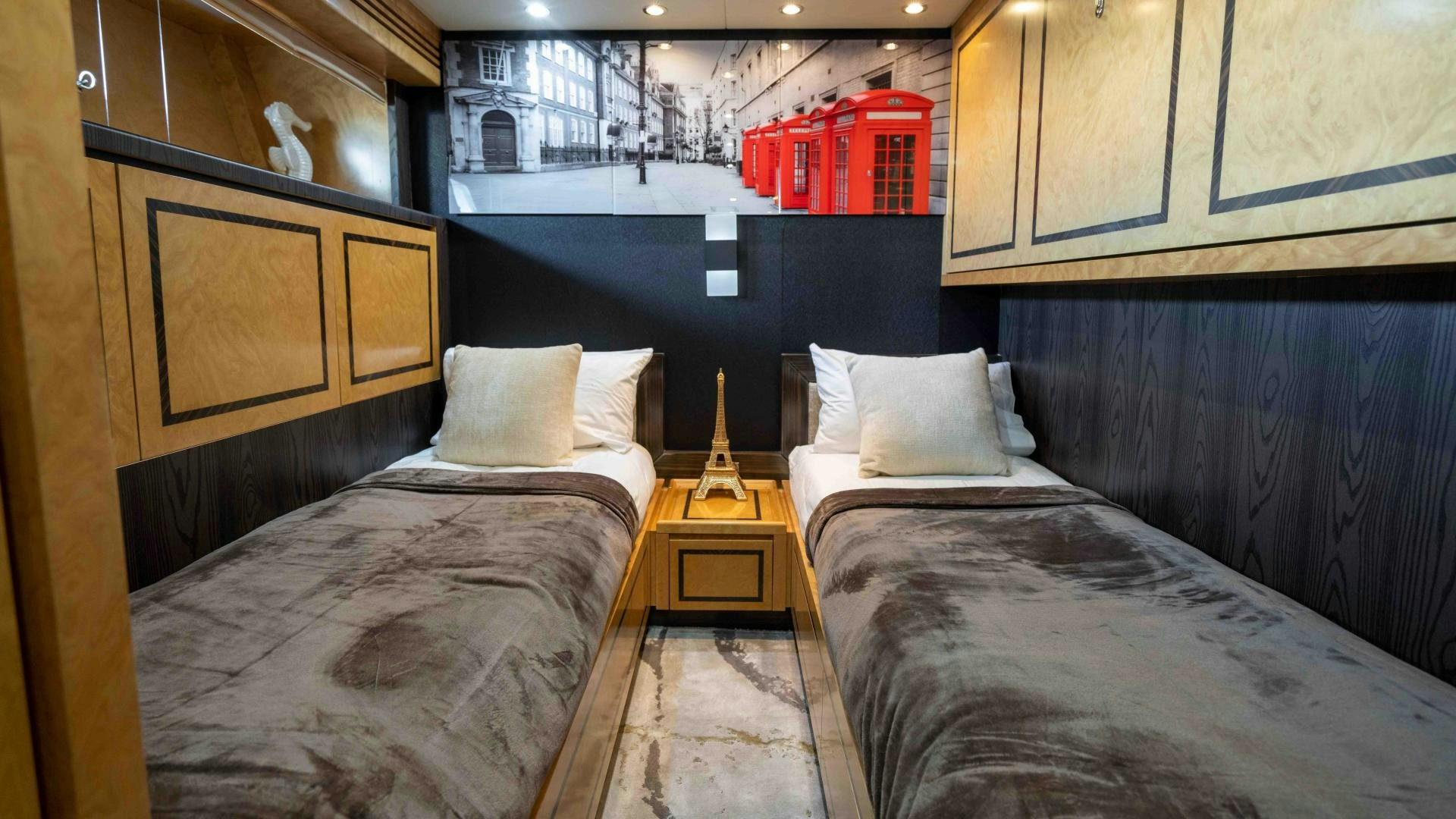 a room with beds and a window aboard ENCORE Yacht for Sale