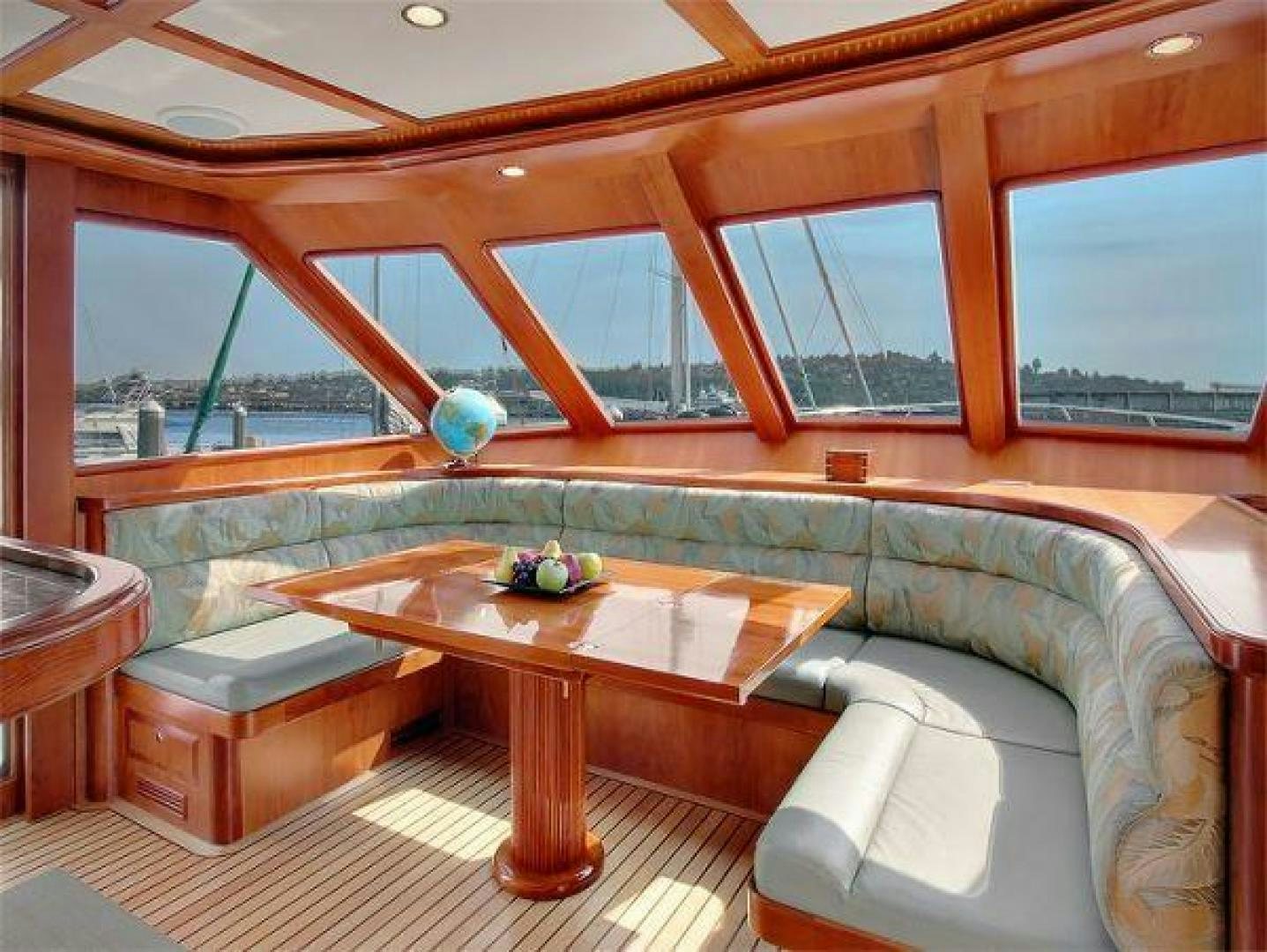a room with a table and couch aboard FOLIE DEUX Yacht for Sale