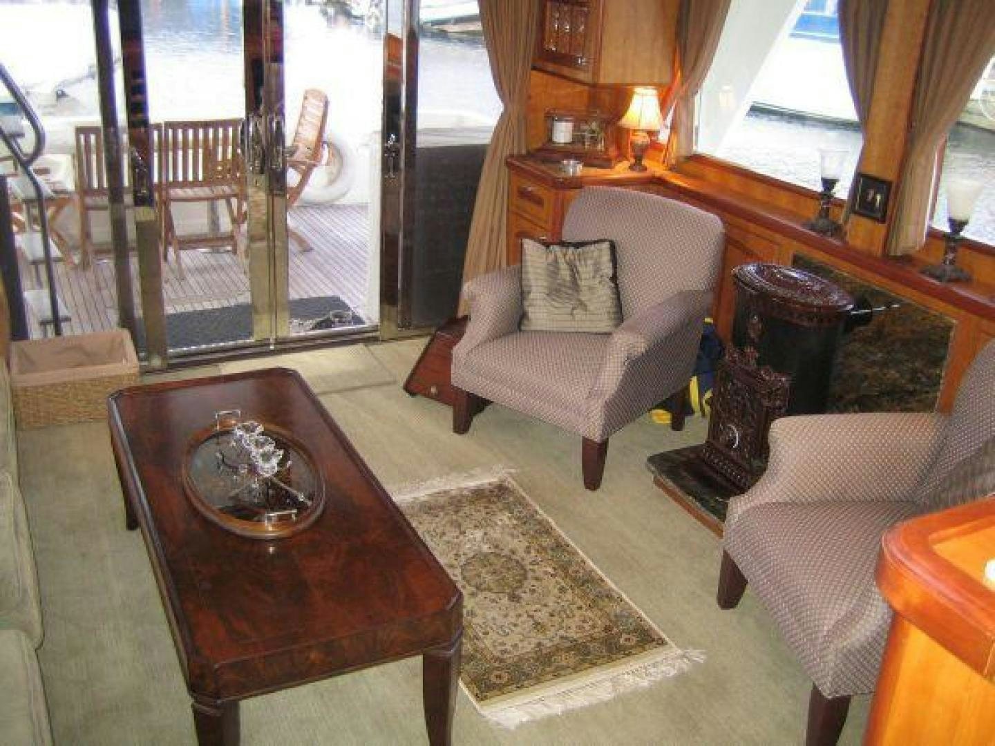 a living room with a table and chairs aboard FOLIE DEUX Yacht for Sale